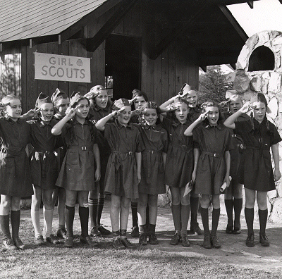 Girl Scouts saluting during a World War II salvage drive