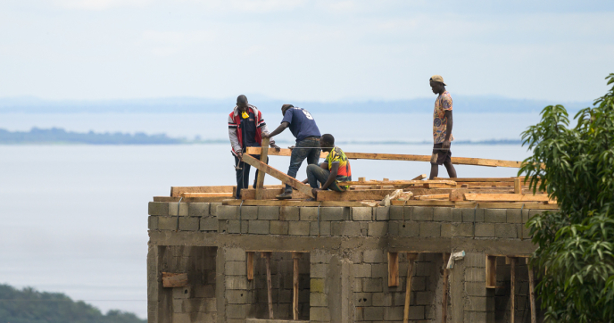 Construction works build a house in Bugala Island, Uganda