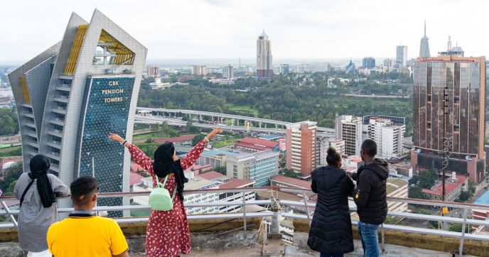 People lookout onto the city from a rooftop in Nairobi City, Kenya