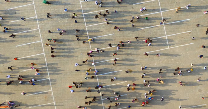 Drone shot of a crowd of people in a parking lot in Nigeria